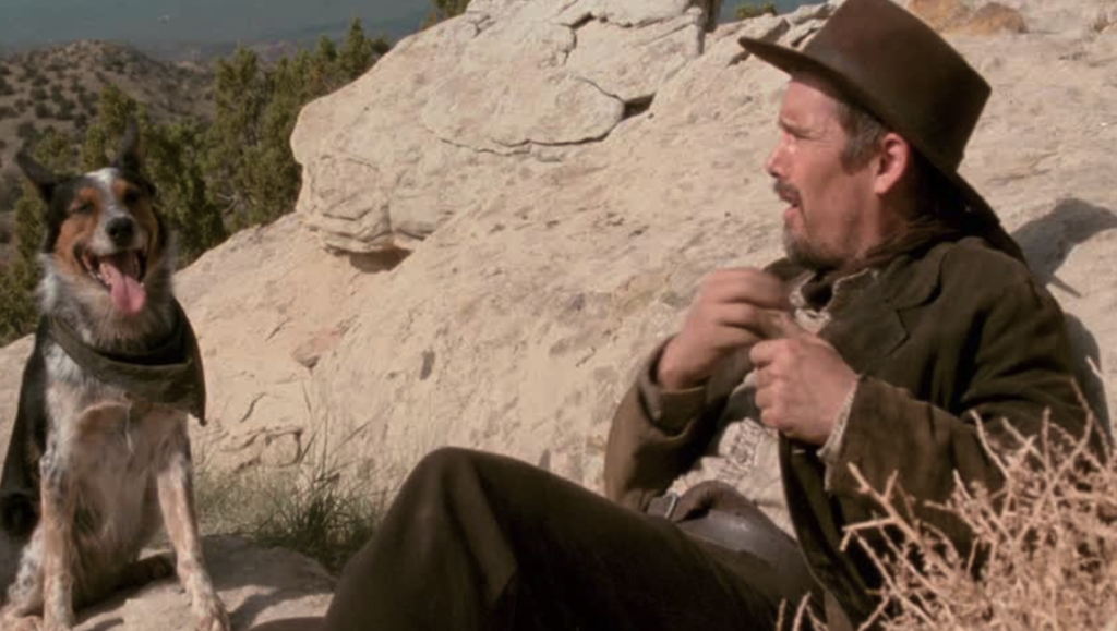 Ethan Hawke in In a Valley of Violence with his dog. Western film scene.