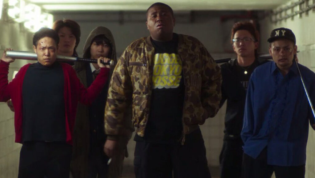 Love and Other Cults | Eiji Uchida Love and Other Cults film still. A group of young men, some holding bats, stand in a tunnel. Eiji Uchida movie scene.