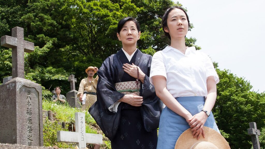 Nagasaki: Memories of My Son | Yôji Yamada Nagasaki: Memories of My Son movie scene. A woman in a kimono at a gravesite with family.