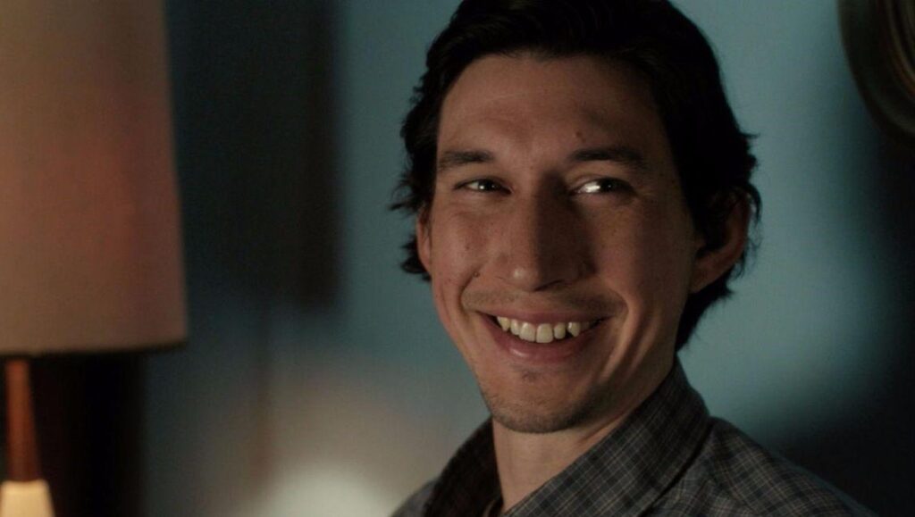 Adam Driver in Paterson, a Jim Jarmusch film. Close-up of Driver smiling.