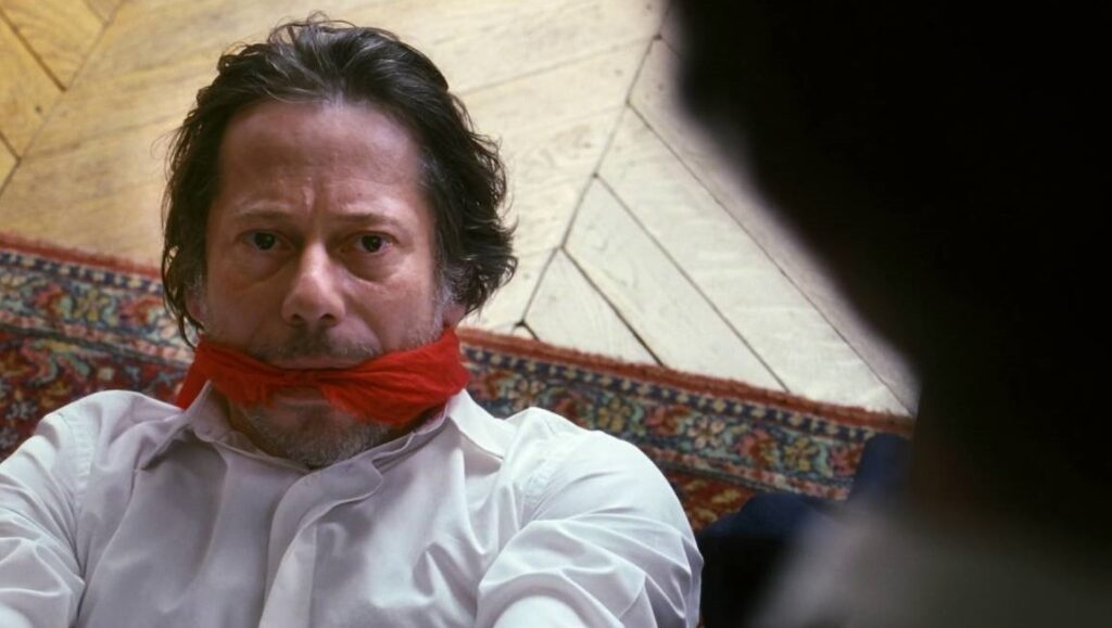 Son of Joseph film still: Man gagged with red cloth. Eugene Green movie scene.