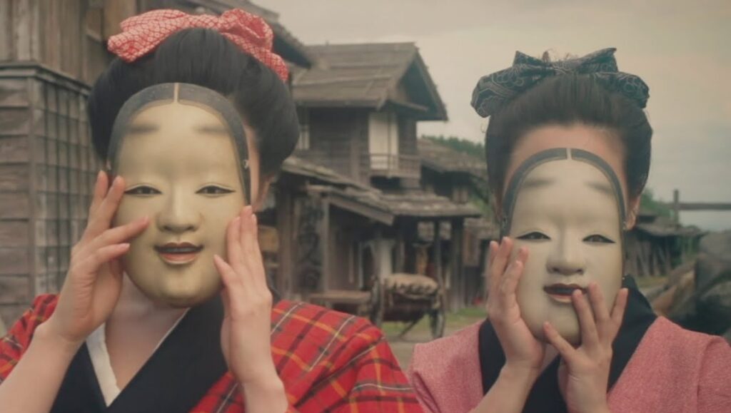 Suffering of Ninko | Norihiro Niwatsukino Suffering of Ninko film still: Two women wearing traditional Japanese Noh masks.