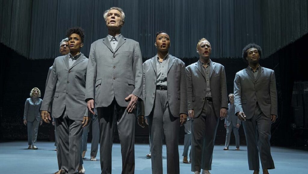 David Byrne's American Utopia. Performers in gray suits on stage. Spike Lee film.