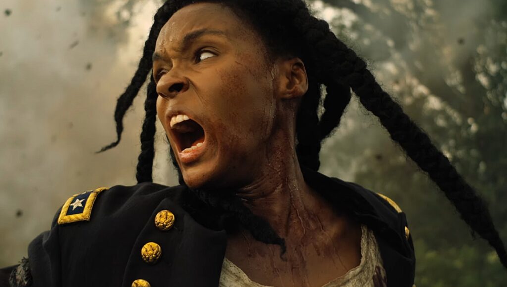 Antebellum | Gerard Bush & Christopher Renz Janelle Monáe in Antebellum movie. Woman with braids, bloodied face, wearing a Union army jacket, screams.