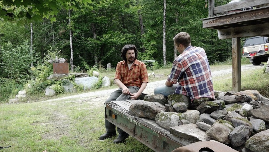 Build the Wall | Joe Swanberg Joe Swanberg's Build the Wall scene. Two men sit outdoors, one with a beard, in plaid shirts, discussing wall construction.