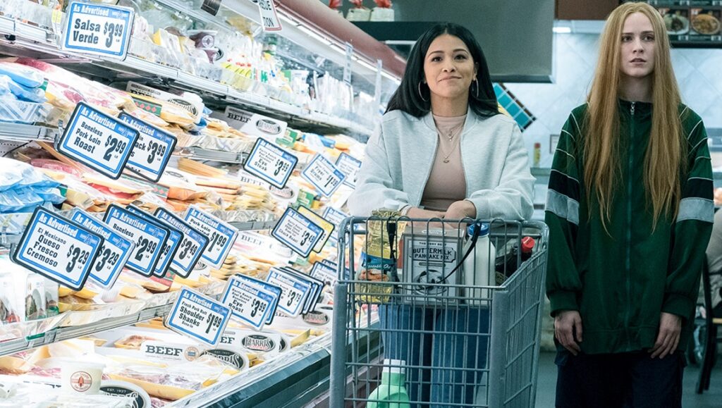 Kajillionaire | Miranda July Kajillionaire movie still: Two women in a supermarket aisle with meat and cheese.