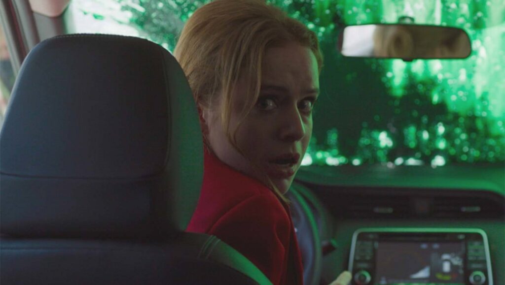 New Order | Michel Franco New Order movie scene. Blonde woman in car, looking back with concern. Michel Franco film.