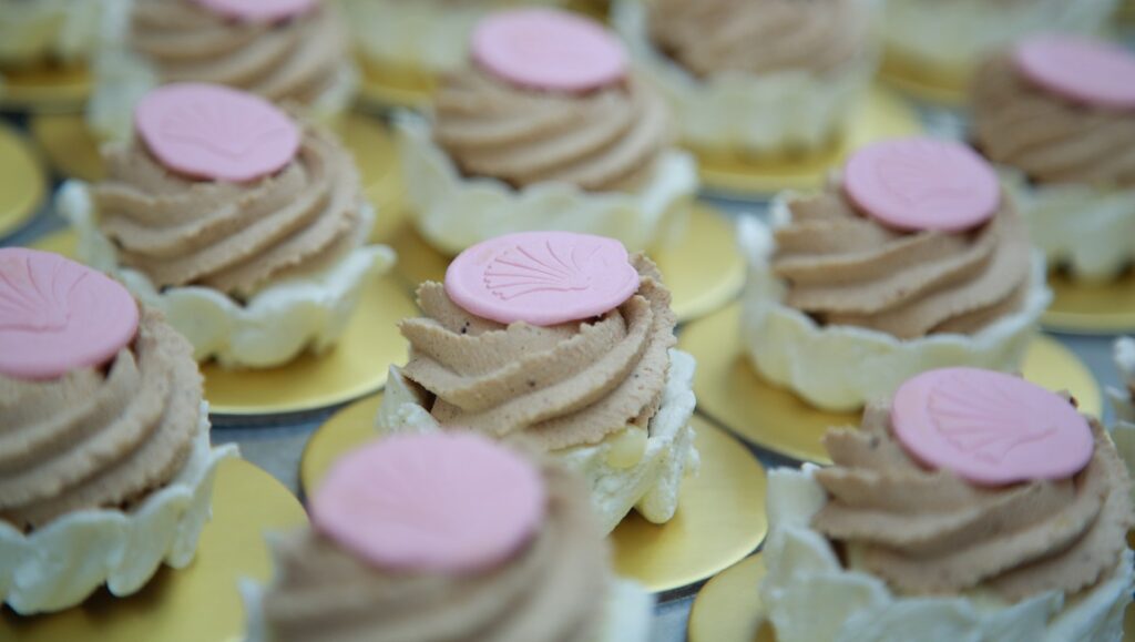 Ottolenghi and the Cakes of Versailles | Laura Gabbert Ottolenghi Cakes of Versailles: Mini chocolate cupcakes with pink toppers. Delicious dessert pastries.