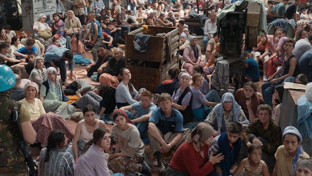 Quo Vadis, Aida? film scene. Crowd of refugees in a large room, guarded by a UN soldier. TIFF 2020 film festival.