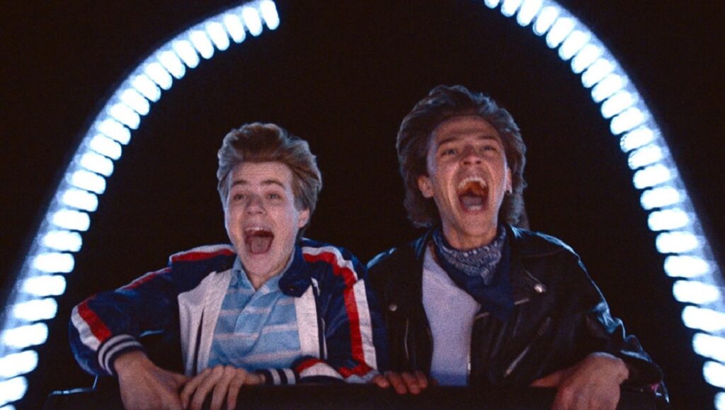 Summer of 85 film still. Two young men on a rollercoaster, mouths open, excited. TIFF 2020.