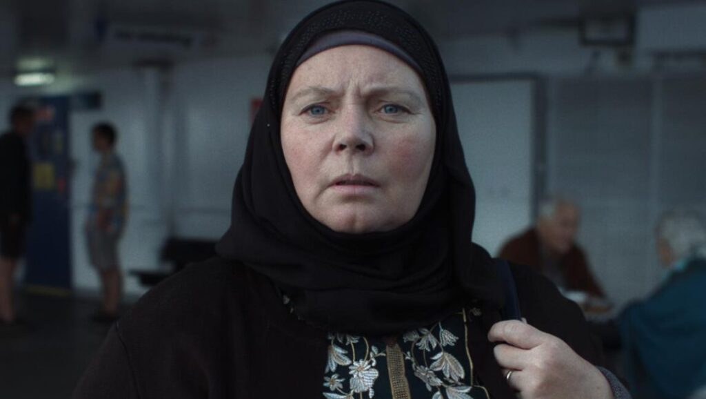 After Love | Aleem Khan Joanna Scanlan in After Love movie. Woman wearing a hijab looks concerned.