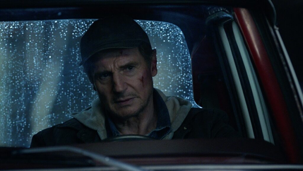 Liam Neeson in Honest Thief. Actor in a car during a rainy night. Mark Williams film.