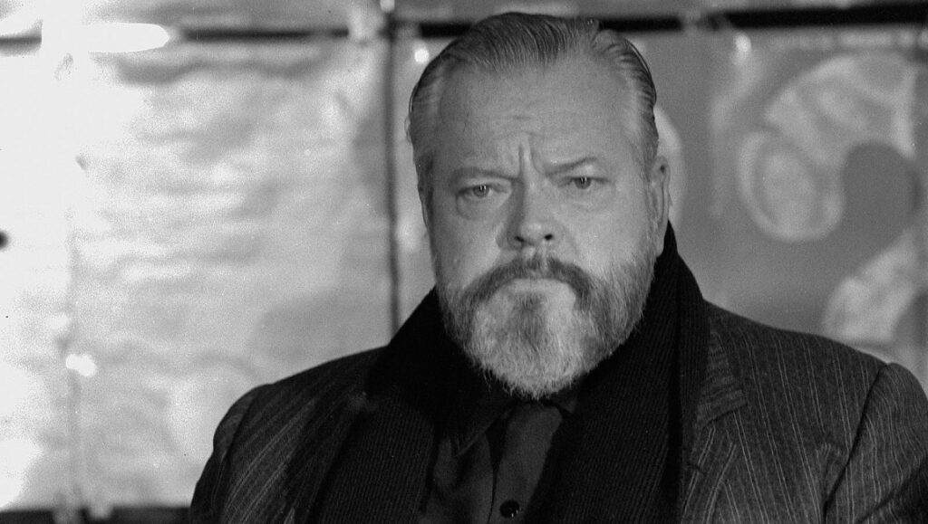 Orson Welles in Hopper/Welles at NYFF 2020. Black and white portrait of Welles with a beard.