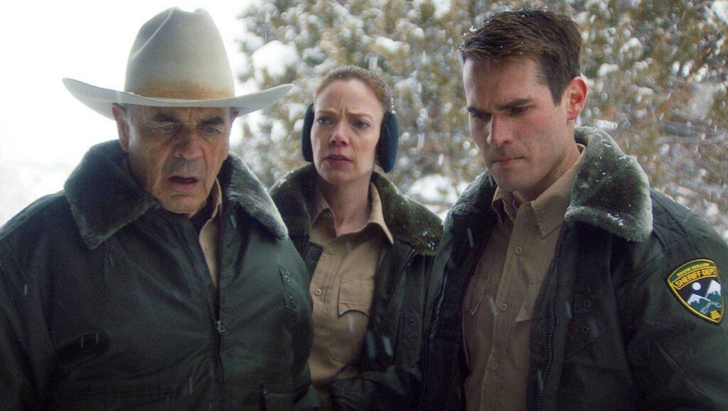 The Wolf of Snow Hollow | Jim Cummings The Wolf of Snow Hollow cast. Jim Cummings movie scene with law enforcement in the snow.