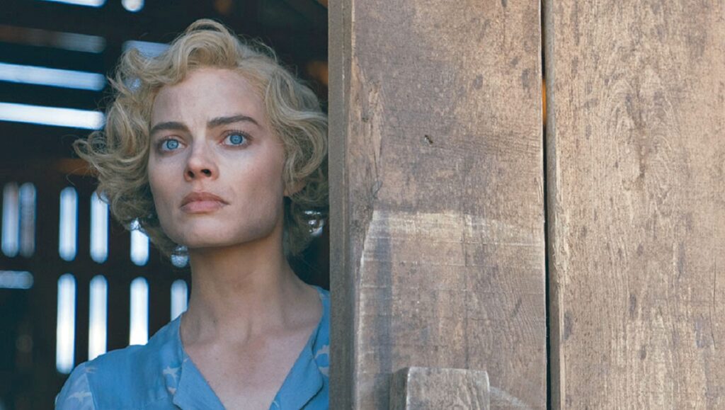 Before We Vanish | November 2020: Dreamland, Zappa, Monsoon Margot Robbie in Dreamland. The actress with blonde curly hair and blue eyes looks out from behind a wooden door.
