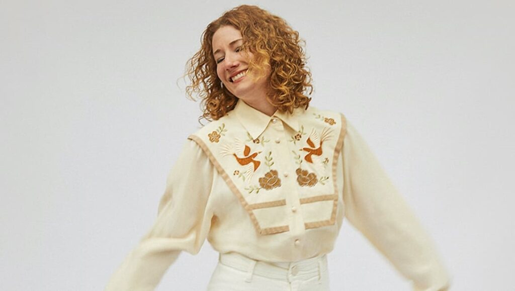 Kathleen Edwards | Total Freedom Kathleen Edwards, Total Freedom album art. Singer-songwriter with curly hair, smiling in an embroidered western shirt.