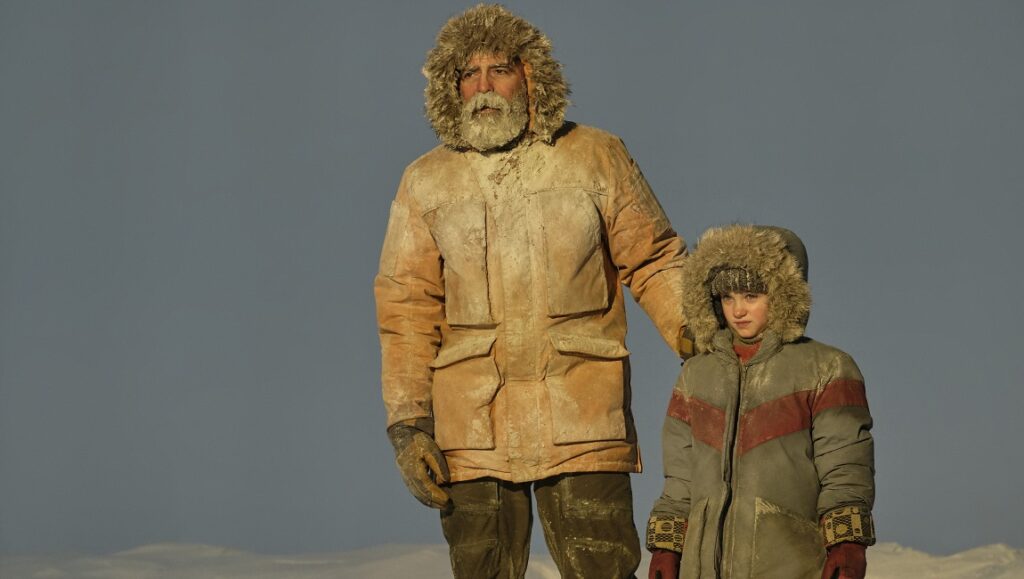The Midnight Sky | George Clooney George Clooney in The Midnight Sky with young actress. Fur-lined winter coats. Post-apocalyptic movie scene.