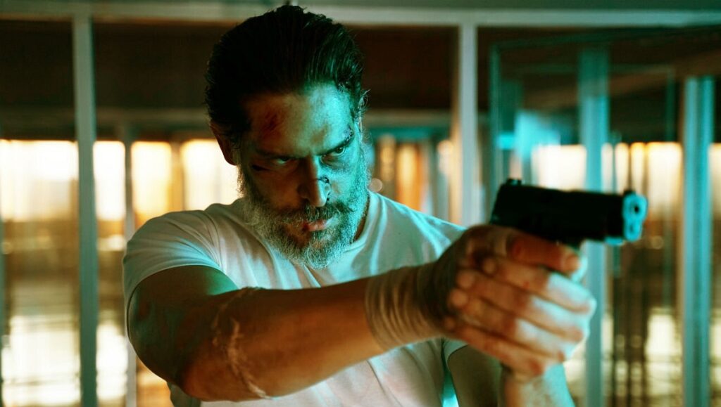 Joe Manganiello as Archenemy. Bruised man points gun. Adam Egypt Mortimer film.