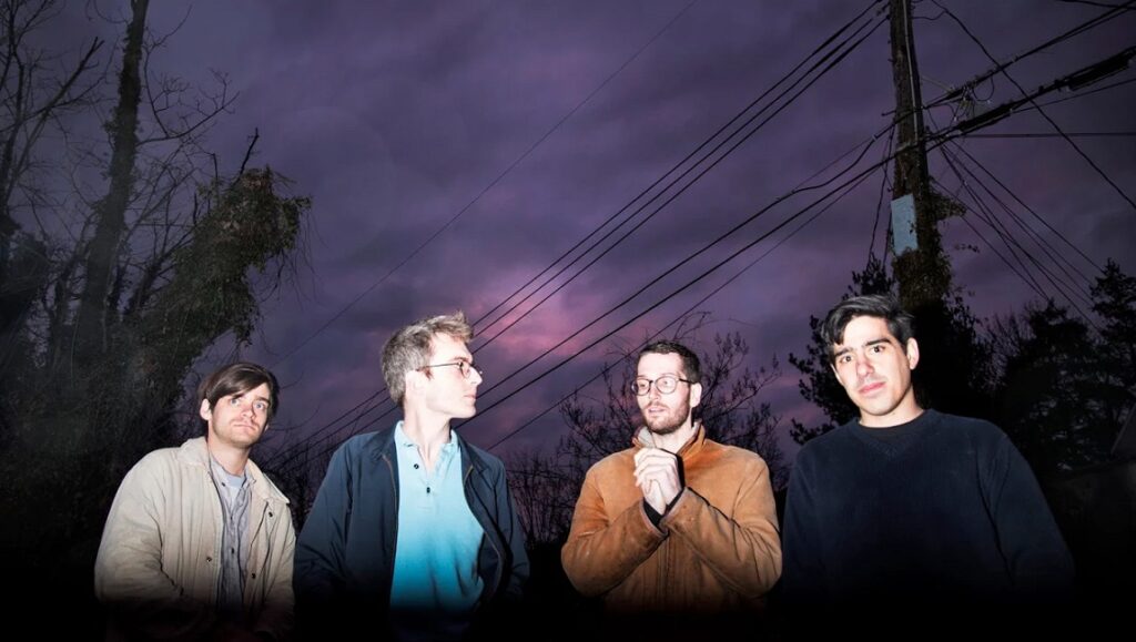 Horselords, one of the top albums of 2020. Band portrait with dark sky. Alternative rock music.