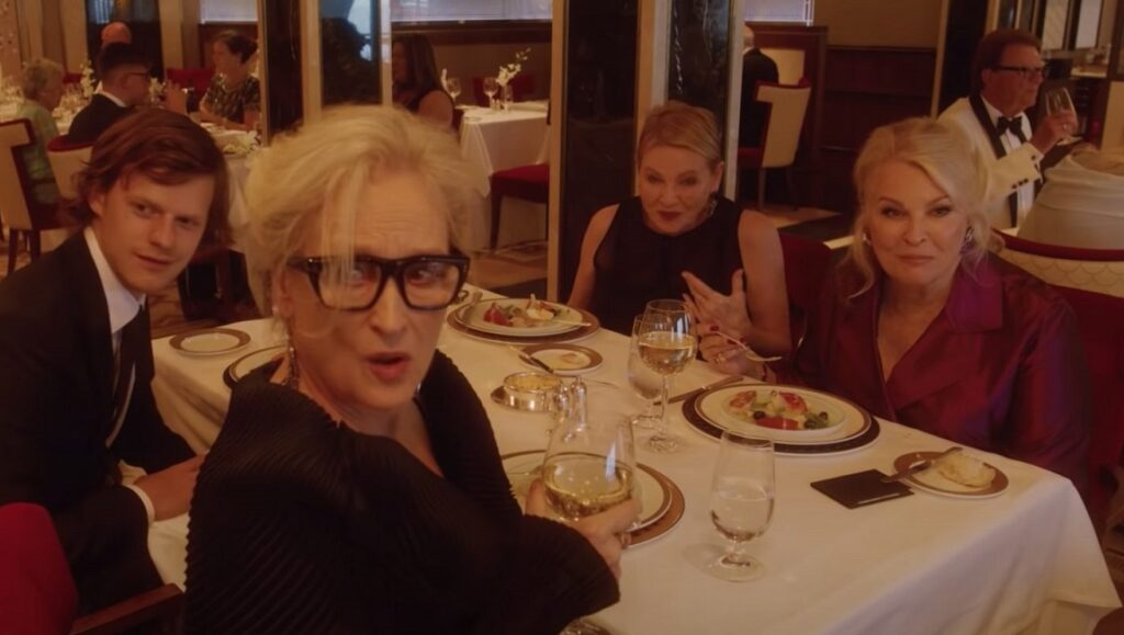 Let Them All Talk cast: Meryl Streep, Lucas Hedges, Candice Bergen, and Dianne Wiest at a dinner table.