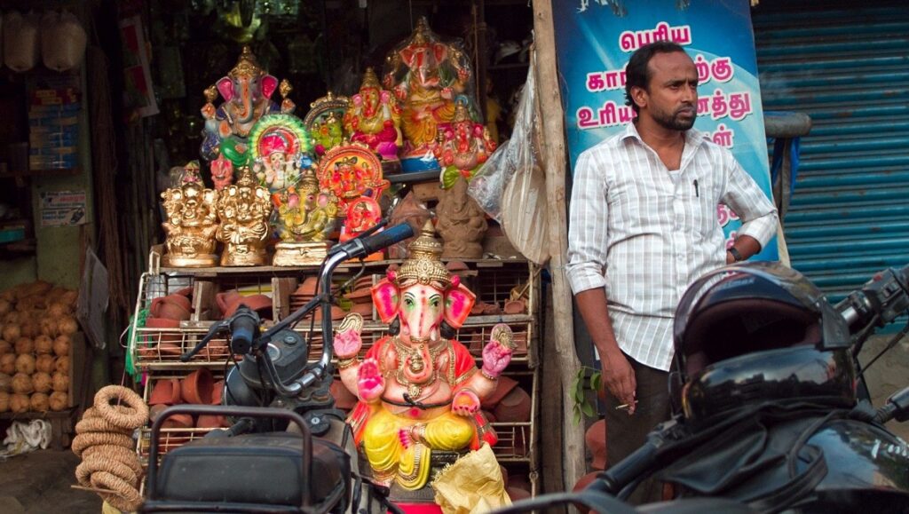 New Directors/New Films 2020 — Dispatch 3: Nasir, The Metamorphosis of Birds, The Cloud in Her Room Nasir film still: Man stands near Ganesha statues at a shop in India. New Directors/New Films 2020.