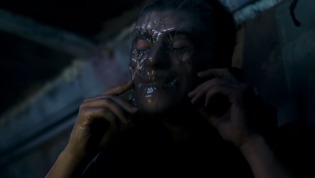 Smiley Face Killers | Tim Hunter Songbird movie still: Person wearing a smiley face mask. Horror film. Before We Vanish. December 2020.