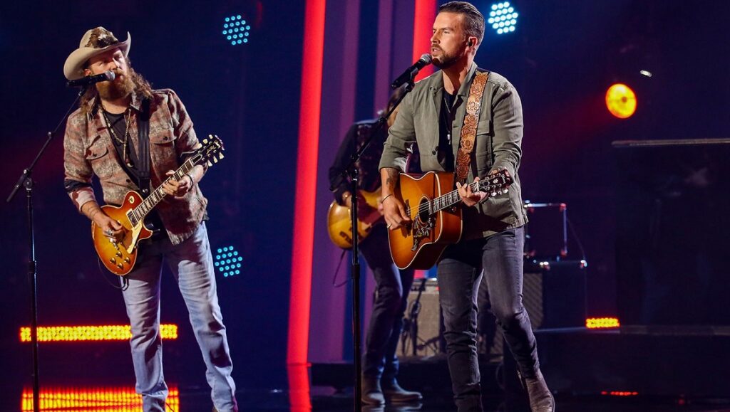 Brothers Osborne | Skeletons Brothers Osborne performing Skeletons. TJ Osborne with guitar and John Osborne in cowboy hat playing guitar on stage.