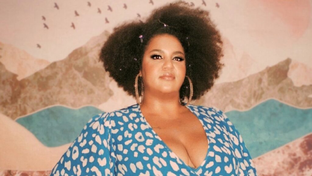 D'orjay the Singing Shaman. Musician with Afro and blue dress. New Kind of Outlaw artist.