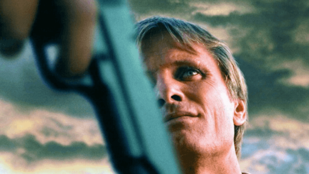 Viggo Mortensen in A History of Violence movie. Gun in foreground.