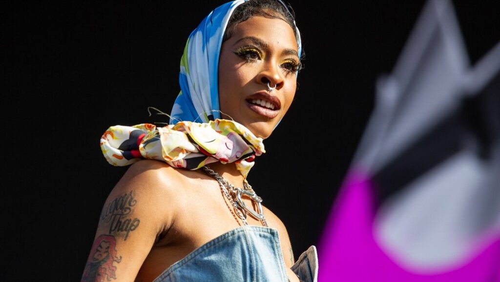 Rico Nasty performing live for Nightmare Vacation. Rapper with headscarf, tattoos, and jewelry.