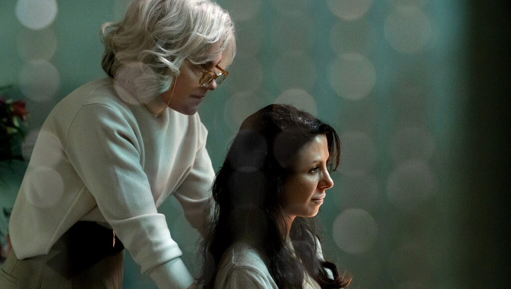 Mitra | Kaweh Modiri Still from Mitra at IFFR 2021. Woman with glasses looks down at another woman with dark hair.