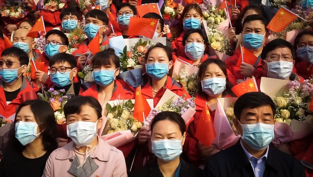 Sundance Film Festival 2021 — Dispatch 7: In the Same Breath, Summer of Soul, Ailey In the Same Breath at Sundance Film Festival. People wearing masks holding Chinese flags and flowers.