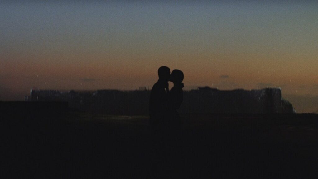 The Wanting Mare | Nicholas Ashe Bateman The Wanting Mare film still: Silhouette of two figures kissing at dusk.