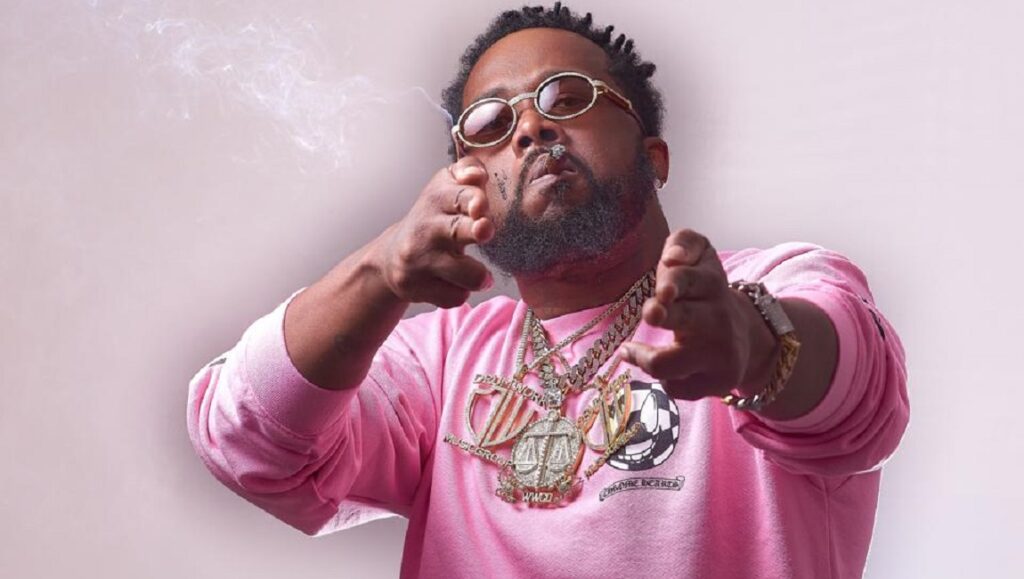 Conway the Machine. Rapper smoking, wearing jewelry and pink sweatshirt. Album Roundup February 2021.