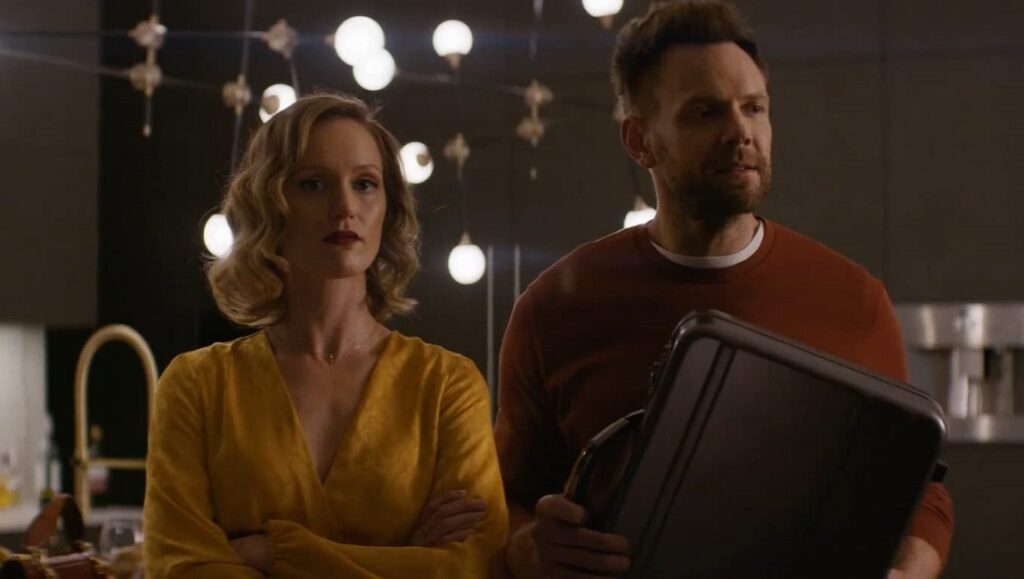 Happily | BenDavid Grabinski Happily movie scene: Kerry Bishé and Joel McHale. Couple with a mysterious briefcase.