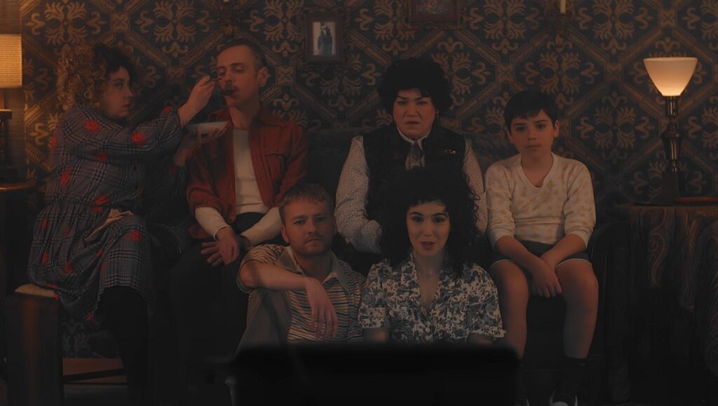 Potato Dreams of America — Wes Hurley Potato Dreams of America film still from SXSW Film Festival 2021. Family watching TV.