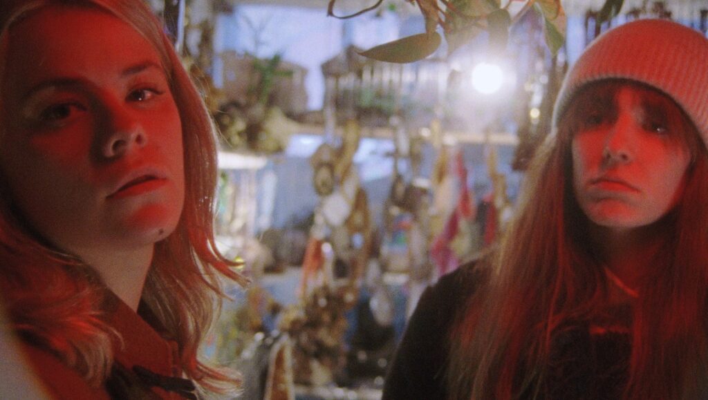 The Scary of Sixty-First film still from Berlin Film Festival 2021. Two women in red lighting.