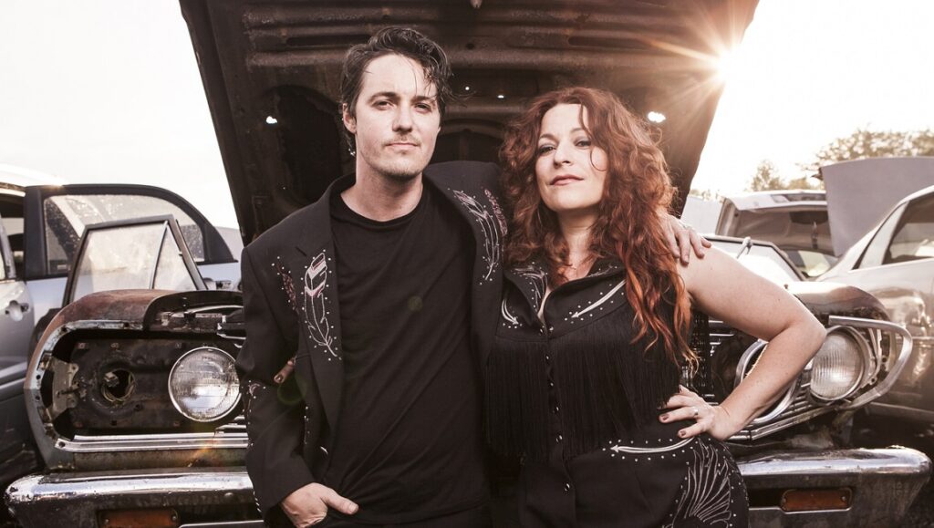 Shovels & Rope album review. The musical duo in front of old cars for February 2021 album roundup.