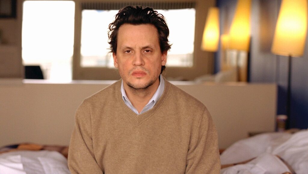 Sun Kil Moon | Lunch in the Park Mark Kozelek portrait. Singer-songwriter with brown sweater in bedroom. Sun Kil Moon artist.