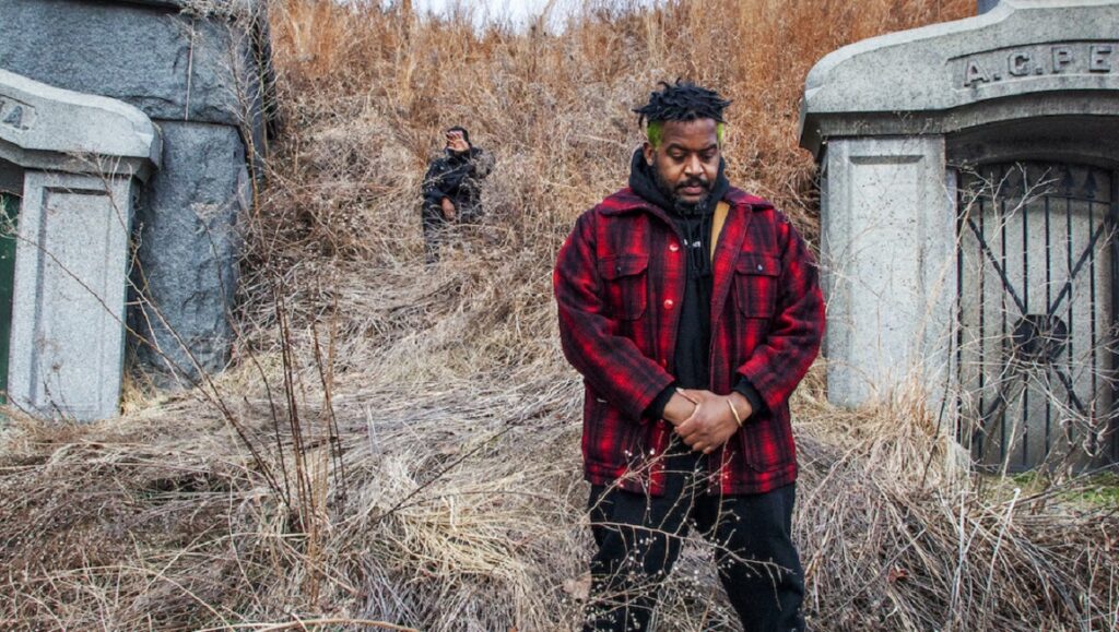 Armand Hammer's Haram album art. The Alchemist collaboration. Rappers in a field with tombstones.