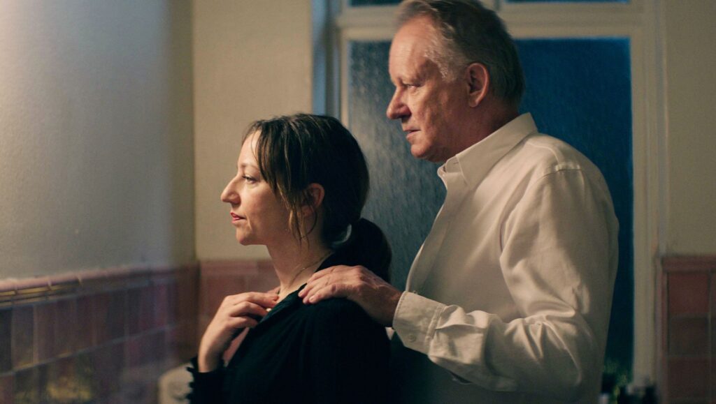 Hope movie image: Woman and man looking out window. Maria Sødahl film.