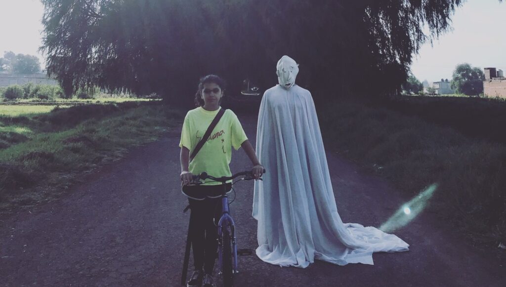 The Howls | Julio Hernández Cordón Between Dog and Wolf, All the Dead Ones, Samichay film scene. Girl with bike, ghostly figure. Neighboring Scenes 2021.