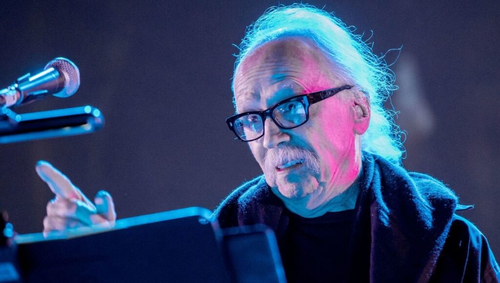 John Carpenter performing live. The legendary horror film director and composer plays keyboard.