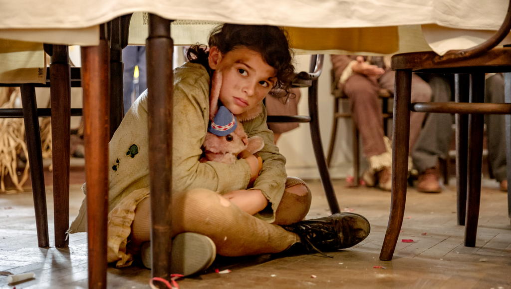 Girl with toy under table. Before We Vanish film still, May 2021. Endangered species, dementia. RK/RKAY movie.