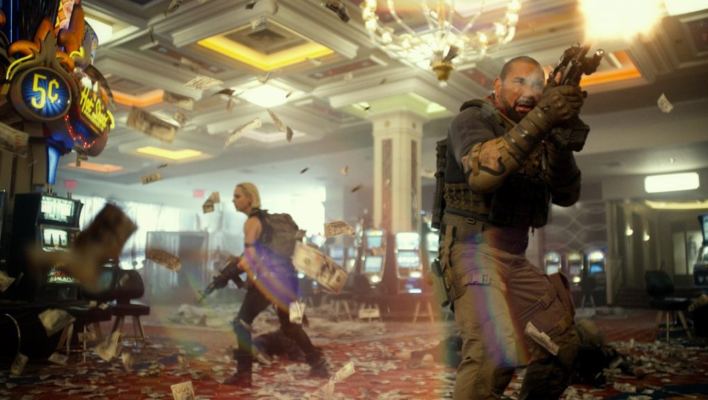 Army of the Dead casino scene: Bautista fires a weapon. Money flies as the team battles zombies in Zack Snyder's film.