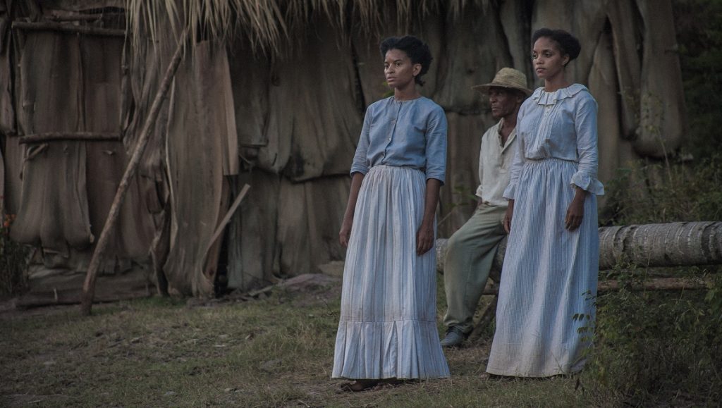 Liborio film still. Two women and a man stand outside a thatched hut. New Directors/New Films 2021.
