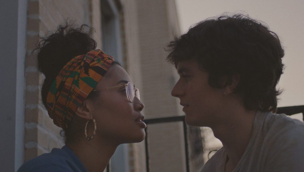 Port Authority | Danielle Lessovitz Close-up of a young couple. Woman with headscarf and glasses facing a man with dark hair. Relationship, love.