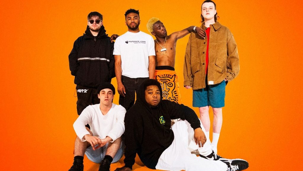 Album Roundup — April 2021 | Part 3: BROCKHAMPTON, Saweetie, The Armed BROCKHAMPTON group portrait. Album Roundup April 2021. Musical artists on orange background.
