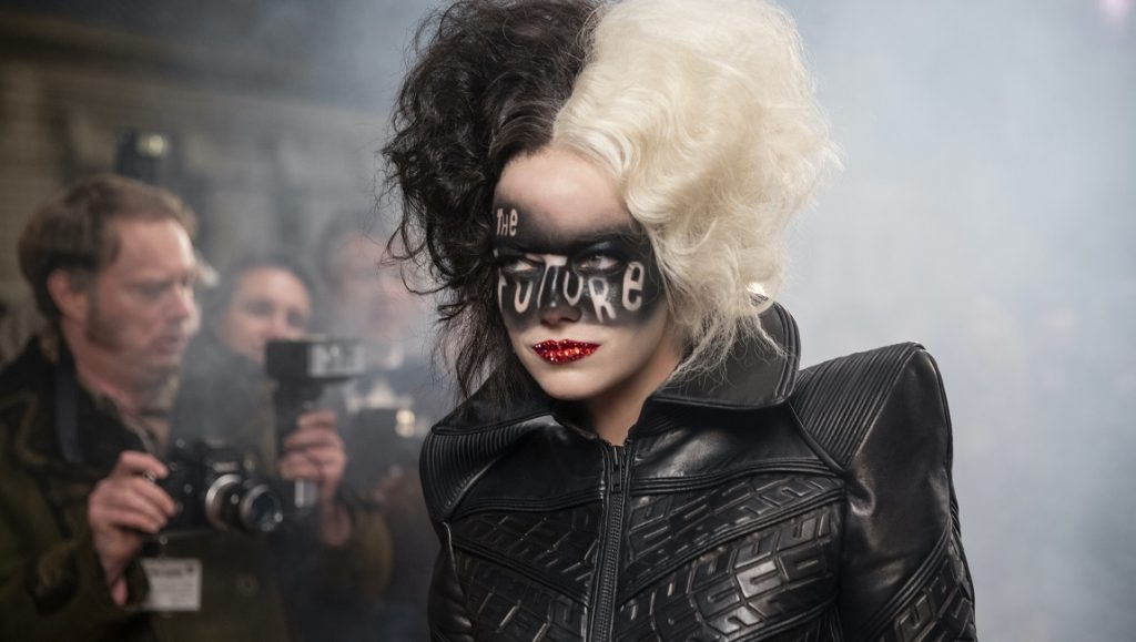 Cruella De Vil: Emma Stone as Cruella. Black and white hair, The Future eye makeup, and a black leather jacket.