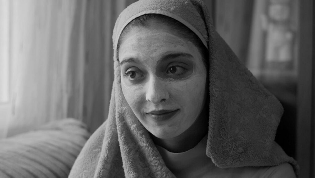 El Planeta | Amalia Ulman El Planeta film still: Woman with beauty mask and towel. New Directors/New Films 2021. Indie cinema.